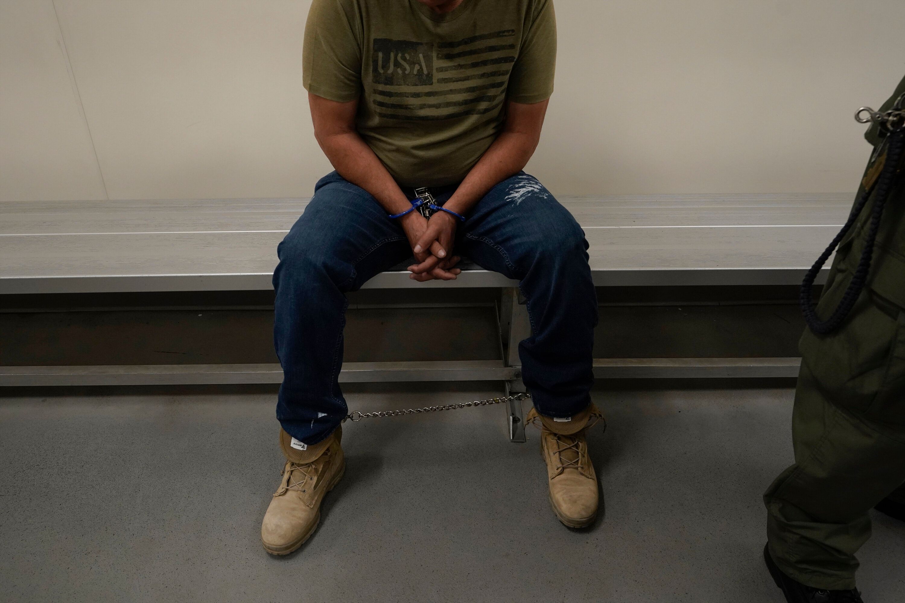 A person considered a threat to public safety and national security waits to be processed at the ICE Metropolitan Detention Center in Los Angeles after a June 6 early morning raid.